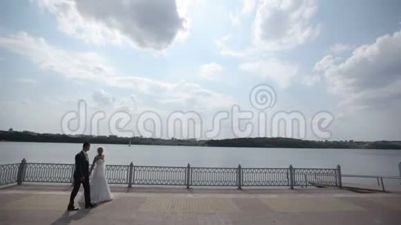 新娘和新郎沿着长廊散步视频的预览图