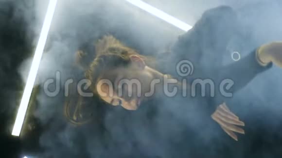 女舞女躺在Smokey舞池上视频的预览图