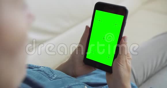 女人拿着绿屏智能手机视频的预览图