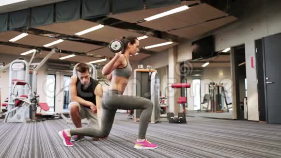 在健身房锻炼杠铃肌肉的男人和女人视频的预览图