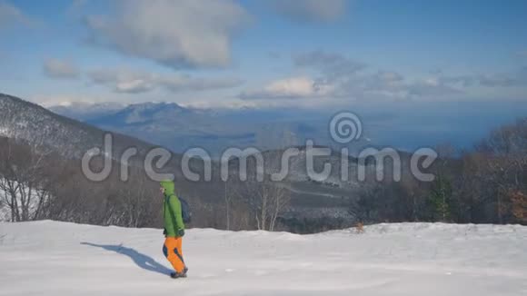 女孩正走在白雪覆盖的森林里徒步旅行冬天的雪景视频的预览图