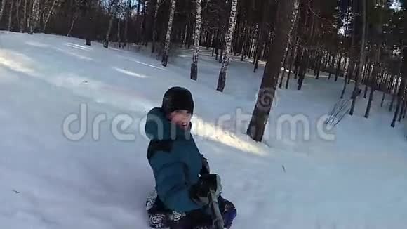 快乐的孩子骑着雪管在雪道上微笑慢动作冬天的雪景户外运动视频的预览图