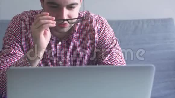 一个人在家工作使用顶部和轨迹板年轻的商人坐在桌子上喝咖啡做工作视频的预览图