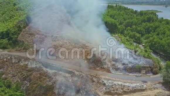 空中观景卡车在燃烧的土地之间沿着公路行驶视频的预览图