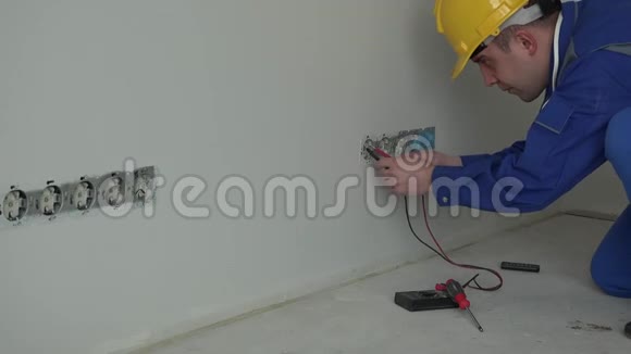 专业男电工使用专用工具检查墙壁插座电压视频的预览图
