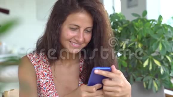 美丽的情感年轻女人在手机上发短信视频的预览图
