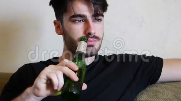 年轻人在沙发上喝啤酒吃东西视频的预览图