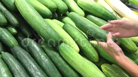 印度尼西亚亚洲农贸市场上选择新鲜有机黄瓜的妇女视频的预览图