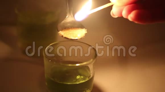 一个人准备一杯苦艾酒糖用烈性饮料滋润在茶匙中燃烧焦糖滴在玻璃杯里视频的预览图