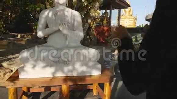 年轻的高加索旅游女孩在泰国普吉岛拍摄白佛雕像高清慢速运动视频的预览图