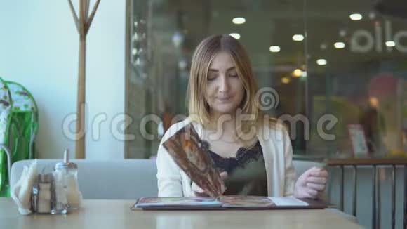 在咖啡厅和餐厅点餐的女士开放菜单年轻女孩叫服务员视频的预览图