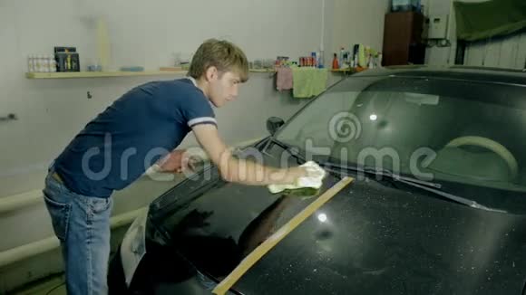 工人用特殊工具擦亮黑色汽车视频的预览图