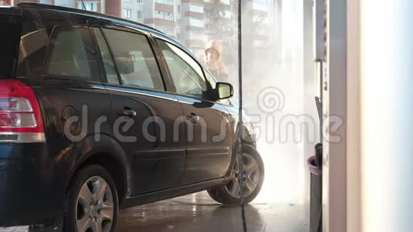 一个男人在室外高压水下洗车视频的预览图