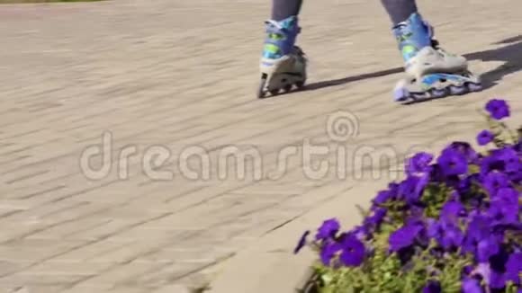 穿滑轮鞋的小孩的腿儿童卷在帕布里克公园慢动作视频的预览图
