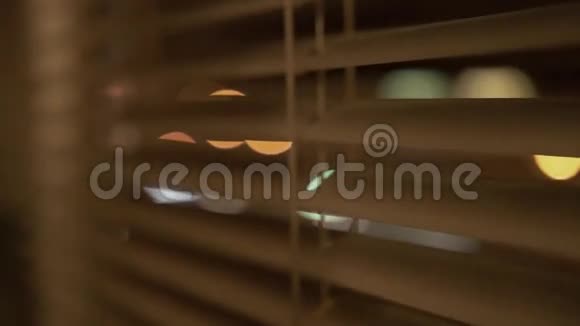 戴眼镜的可爱女孩在晚上看着窗外视频的预览图