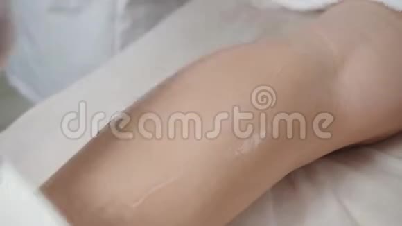 医生在手术中使用凝胶特写激光脱毛和美容女士腿上的脱毛在视频的预览图