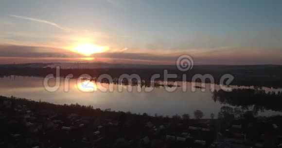 日落时鸟瞰村庄和湖泊4K视频的预览图