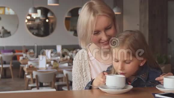 小女孩在咖啡馆喝茶视频的预览图