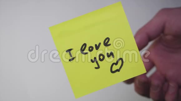 画画我爱你在黄纸上在白色背景上我爱你视频的预览图