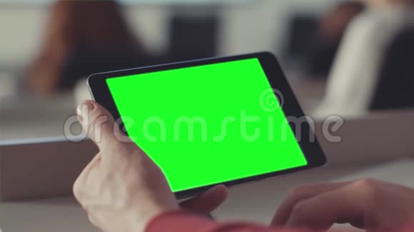 男人用绿色的屏幕看着平板电脑的屏幕库存手中平板电脑屏幕上的Chroma键视频的预览图