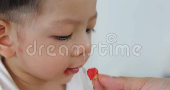 小男孩快乐地吃着妈妈的食物视频的预览图