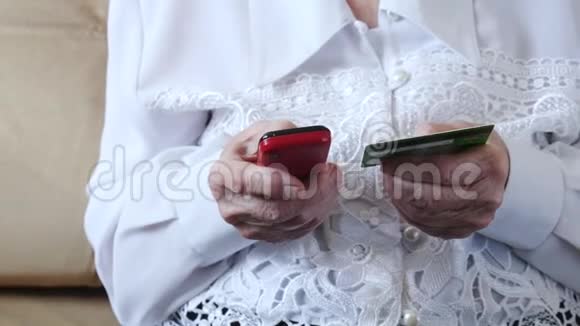 一位在家用手机用信用卡做网上银行的高级妇女视频的预览图