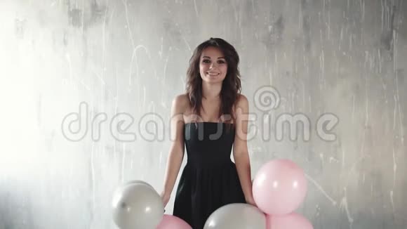 快乐的年轻女子抛出气球和微笑节日的气氛庆祝的感觉慢动作视频的预览图