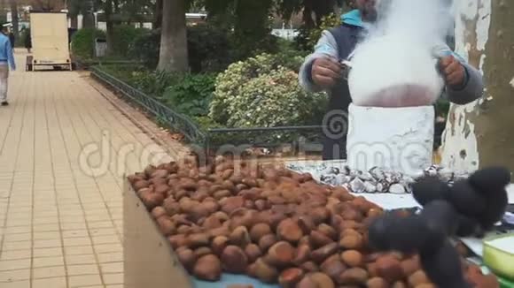 街头小贩在煎锅里烤栗子西班牙塞维利亚视频的预览图