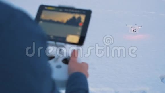在冬天的花园里人的近距离慢镜头控制着一架无人机航班结束视频的预览图