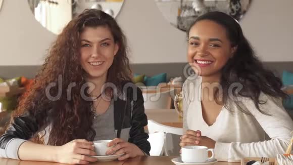 两个女孩在咖啡馆里展示了他们彼此的喜好视频的预览图