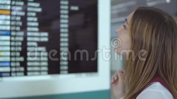 美丽的女孩站着选择飞行背景模糊记分板与通知视频的预览图