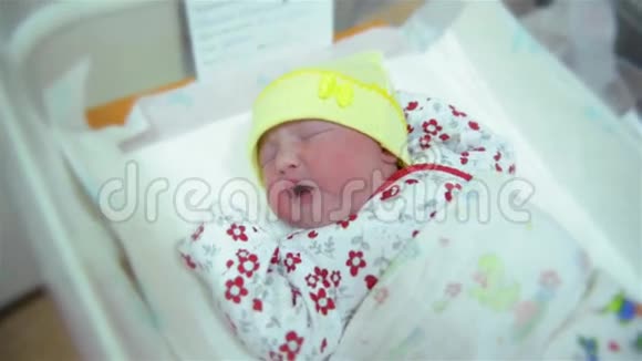 新出生的婴儿在产房的毯子里睡着了婴儿出生后立即哭泣视频的预览图