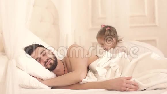 可爱的小女孩叫醒她的父亲拥抱视频的预览图