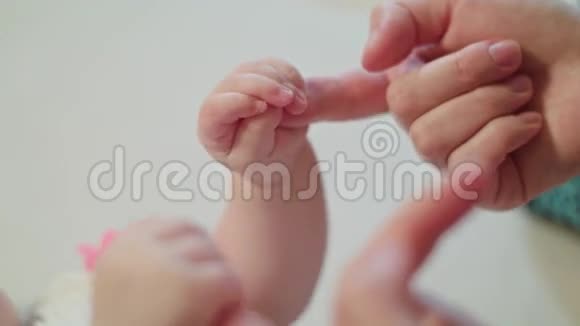 妈妈手指在握着婴儿拳头视频的预览图