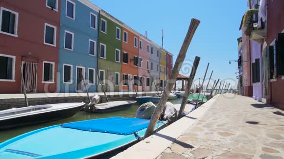 布拉诺岛运河上有摩托艇停泊在街道上还有五颜六色的建筑视频的预览图