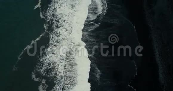 强烈海浪的高空俯视泡沫来到冰岛黑色火山海滩的海岸视频的预览图