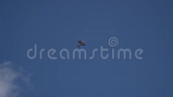 一架有四个翅膀的红白飞机执行特技飞行动作人物变焦攀爬视频的预览图