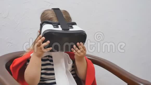 穿红色斗篷的漂亮小女孩用虚拟现实眼镜视频的预览图