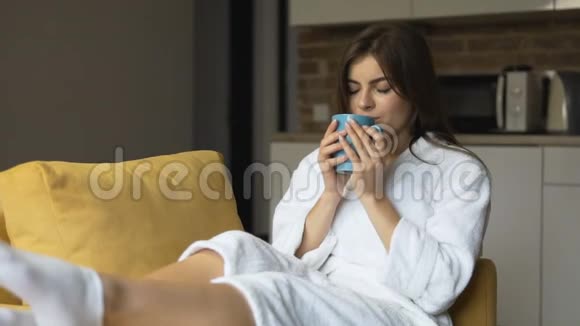 女人在扶手椅上享受咖啡视频的预览图
