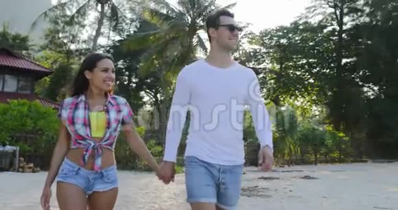 热带棕榈树公园交流中的情侣牵手谈幸福的男人和女人视频的预览图