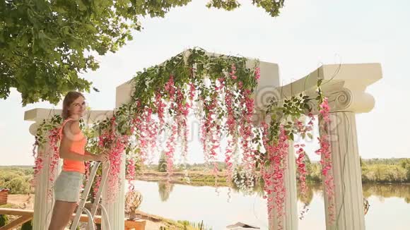 花匠用鲜花装饰婚礼拱门视频的预览图