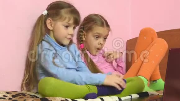 两个女孩选择在笔记本电脑里看到什么视频的预览图