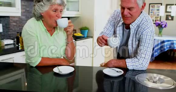 快乐的老夫妻在厨房喝咖啡视频的预览图