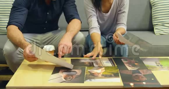 男女平面设计师讨论照片4k视频的预览图