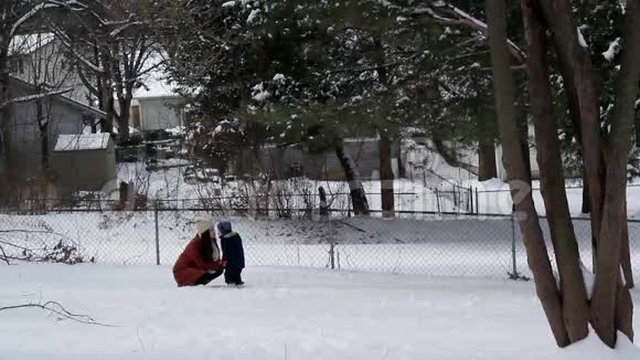 在雪地里行走的妇女和儿童视频的预览图