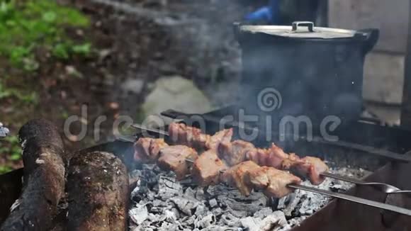 烤串上有美味多汁的炒肉刚在烤架上煮熟在锅的背景下人们和假日的概念烹饪视频的预览图