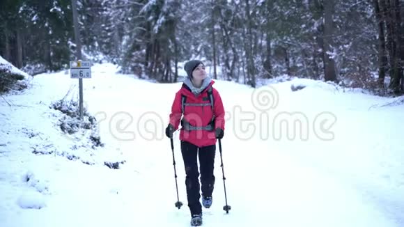 年轻的白种人妇女在大自然中的户外徒步旅行中度过了她的空闲时间覆盖着雪视频的预览图
