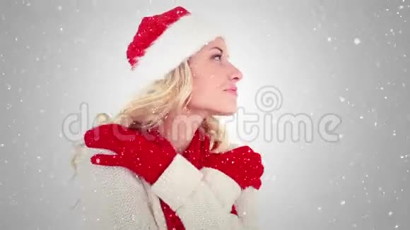 带着圣诞帽微笑的快乐女孩在雪地上拍摄视频视频的预览图