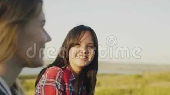 两个迷人的女孩朋友年轻的女性站在高高的山上在夏天的晚上交谈关闭视频的预览图
