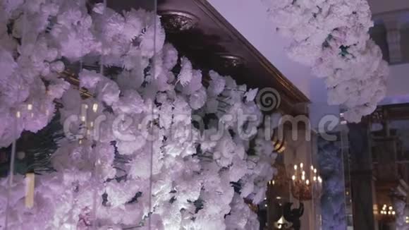 餐厅婚礼装饰及安排一朵朵白色的玫瑰和菊花挂在新婚夫妇的头桌上视频的预览图